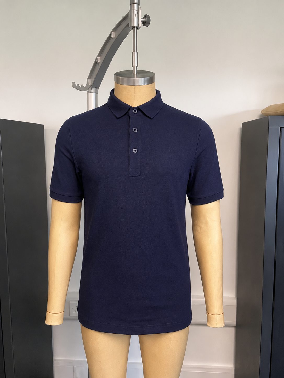Navy knit polo fit sample on tailor form — developed by THELYSH Atelier